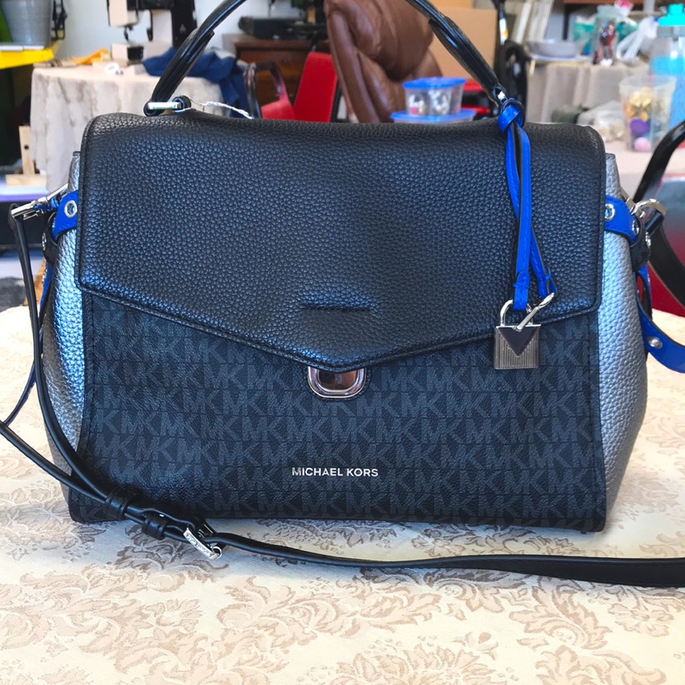 Michael Kors: blue, black, and silver bag.